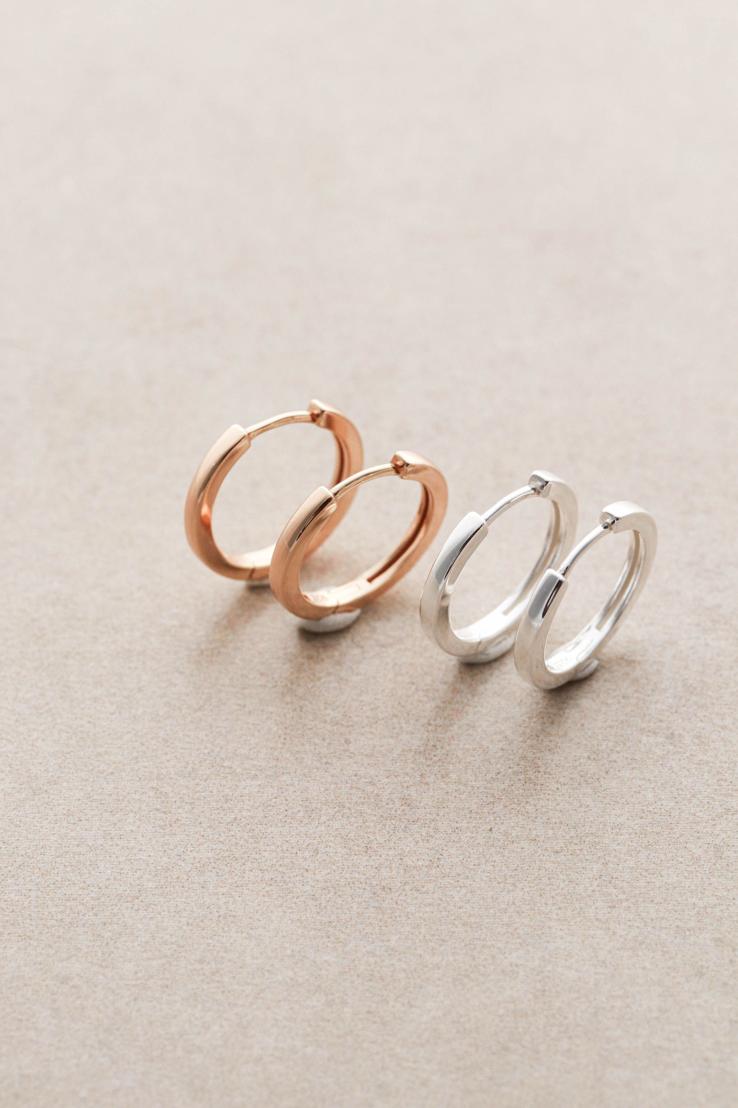 gold and silver huggie hoop earrings close up