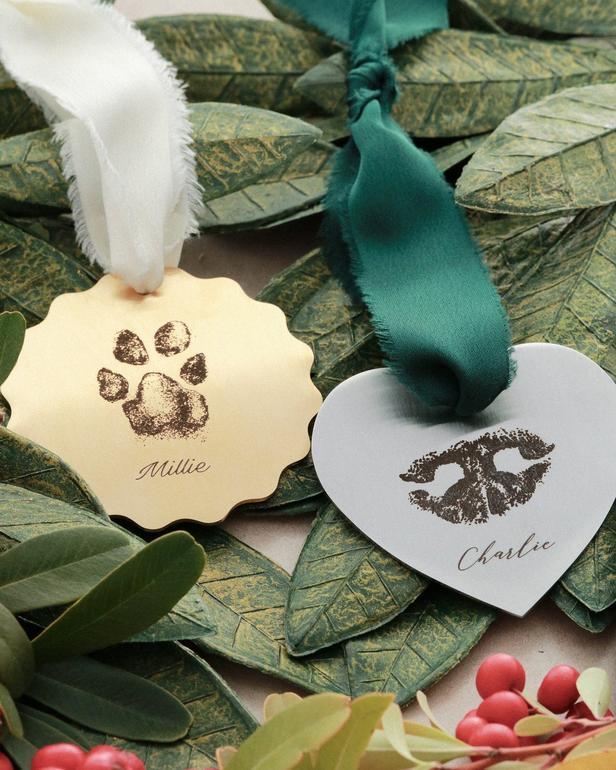 Decorative tags with paw prints and names on green leaves