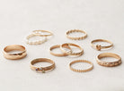 Collection of gold rings on a light gray background