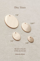 various sizes of gold-filled discs, ranging from 7/8" to 5/8" in size, arranged on a beige background.