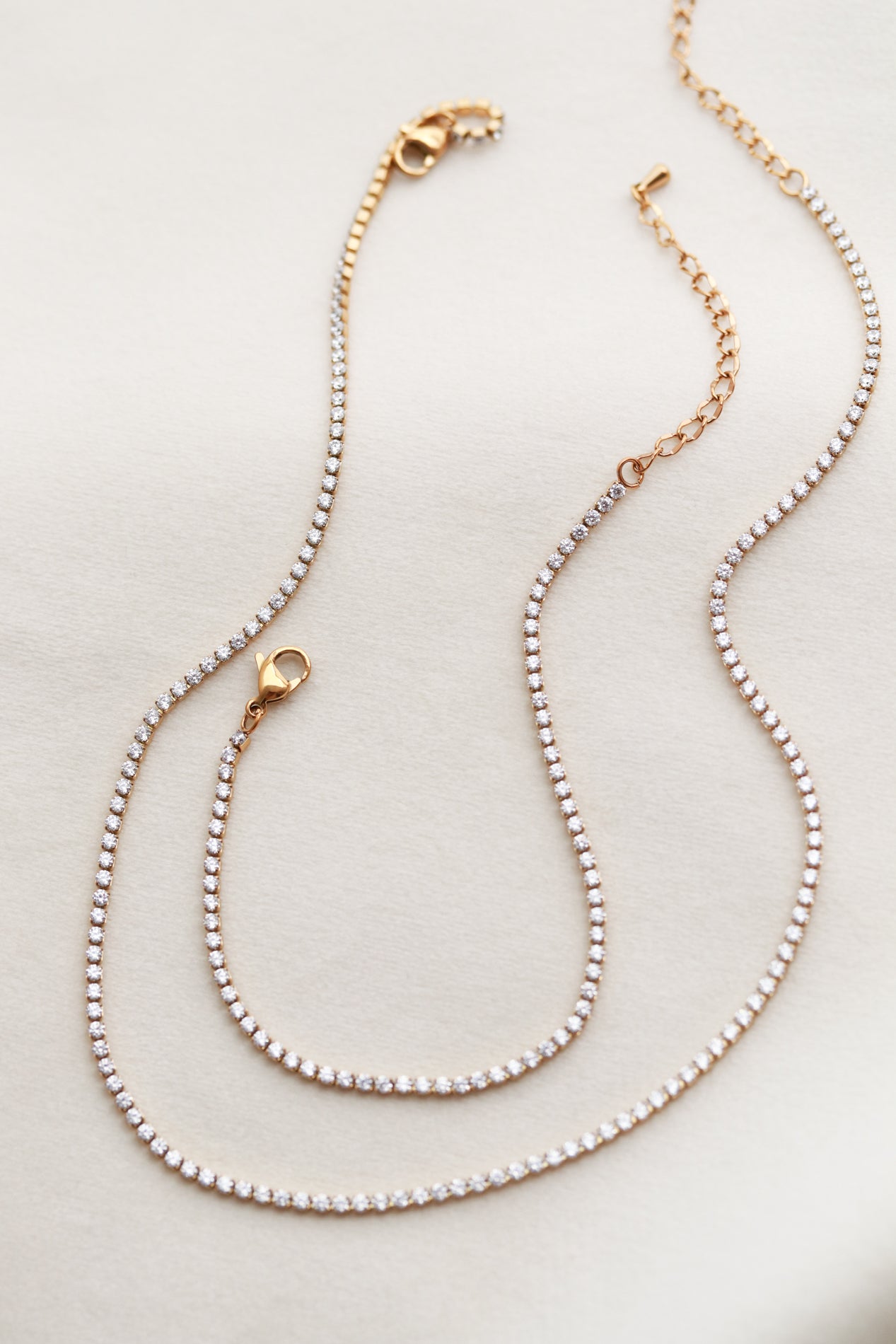 A cz tennis necklace with a series of small, clear rhinestones or crystals.