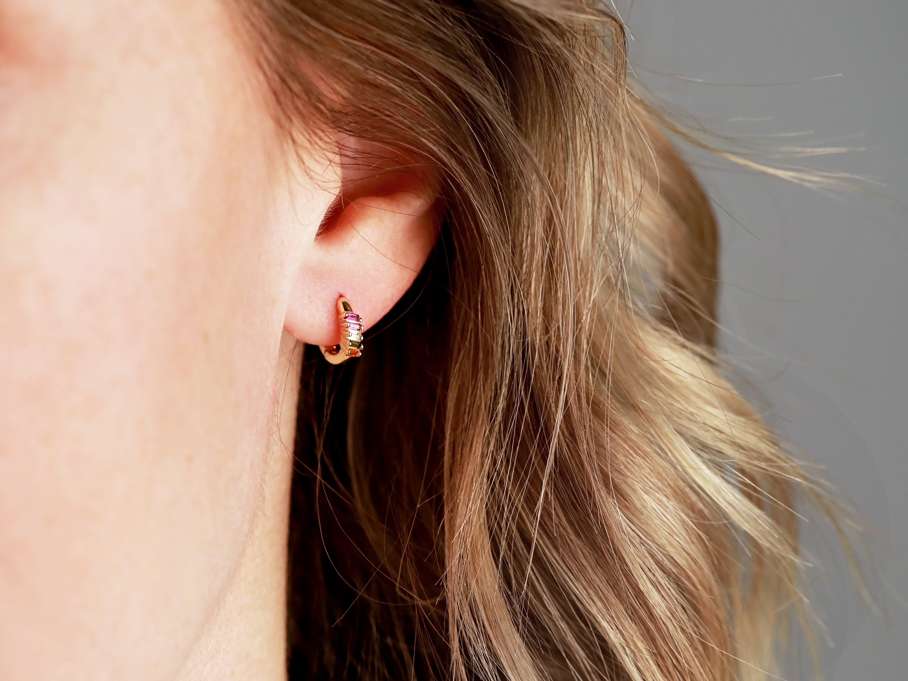 Tiny Rainbow Huggie Earrings by Tom Design Shop.